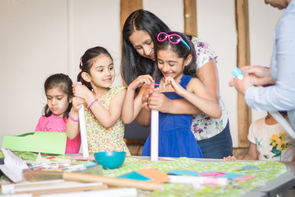 adults and children taking part in arts and crafts at Norden Farm
